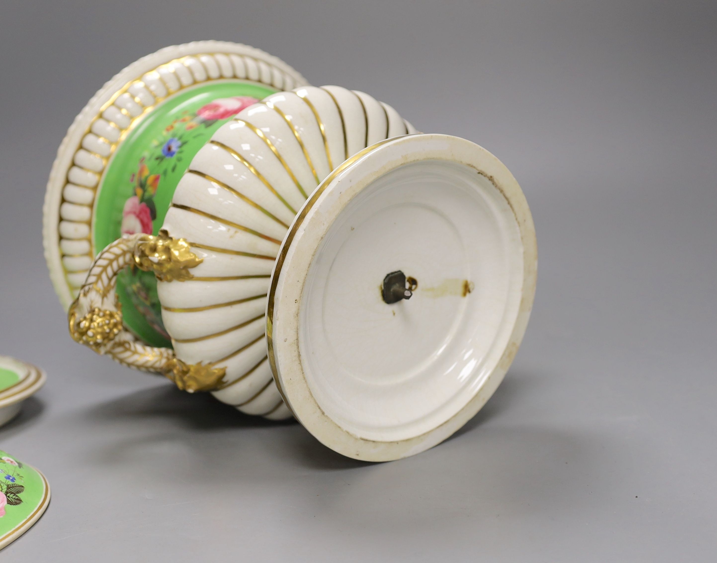 An English porcelain campana shaped ice pail and two covers painted with flowers and a green ground, c.1830 (handles re-attached) 30cm